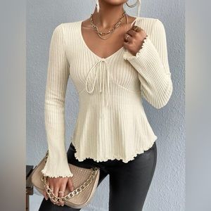 lettuce trim, ribbed, knit sweater with bell sleeves and bow detail